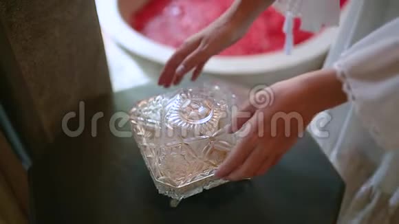 一个年轻的女人用玫瑰花瓣洗澡喝一杯饮料水疗和放松视频的预览图