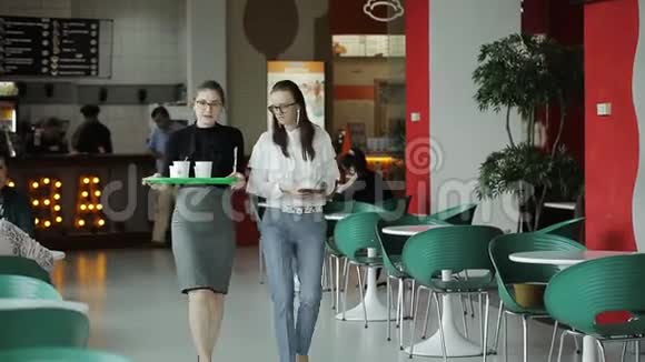 两个商务妇女在自助餐厅工作休息喝咖啡和讨论商业问题视频的预览图