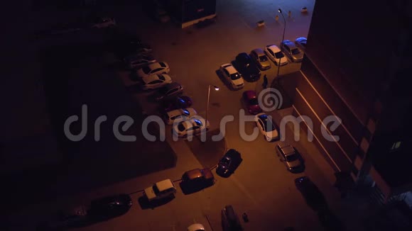 晚上从摩天大楼屋顶俯瞰停车场由各种车辆在黑暗中停放视频的预览图