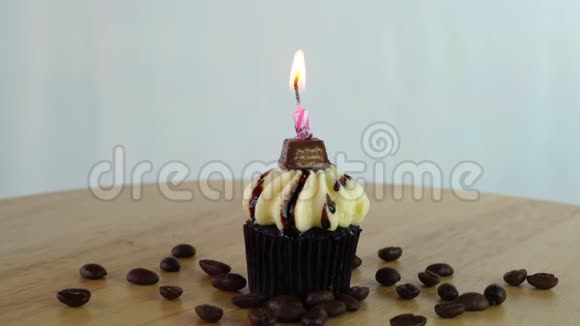 巧克力蛋糕生日蜡烛和咖啡豆在木板上移动视频的预览图