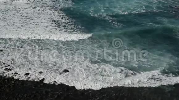 白色泡沫破碎的海浪在海滩上黑色火山沙在特内里夫视频的预览图