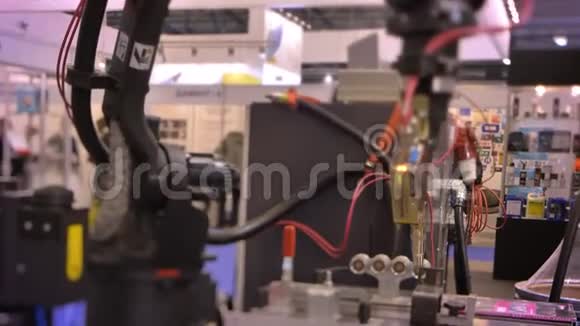 在展览背景下拍摄工作的黑色激光自动机械臂视频的预览图
