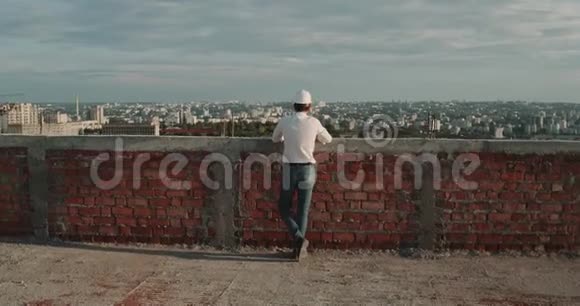 令人惊叹的城市景观从屋顶建筑一个人戴着安全帽站起来看着周围视频的预览图