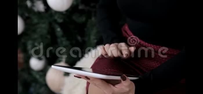 一个女佣在圣诞节的气氛中给她的平板电脑写了一封信视频的预览图