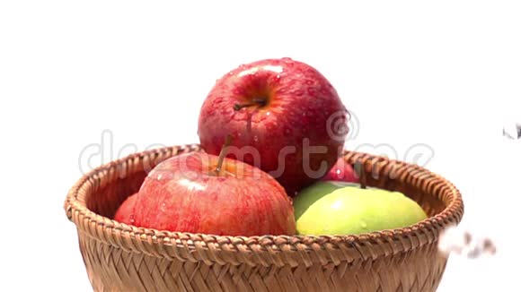 在白色背景的竹篮里浇红苹果和绿苹果视频的预览图