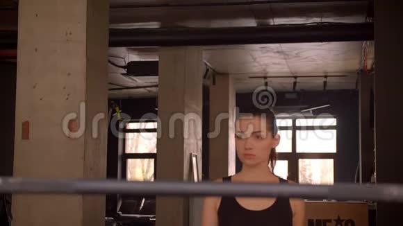 年轻有魅力的运动员女健步走准备在室内健身房举重的特写镜头视频的预览图
