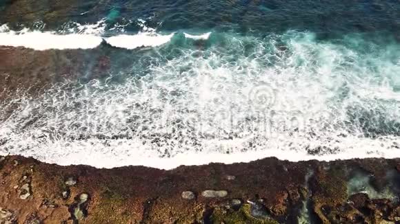 巨型波浪海洋泡沫和飞溅的顶部景观阳光明媚的一天慢动作视频印度尼西亚巴厘岛视频的预览图