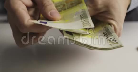 数着两百欧元钞票的男性手的特写视频的预览图