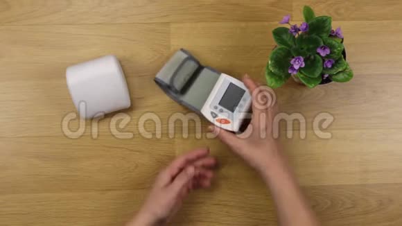 女人测量桌子上血压的手视频的预览图