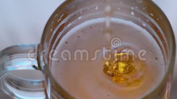 新鲜泡沫啤酒倒入啤酒杯慢动作视频的预览图