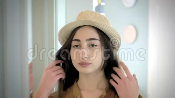 时髦的年轻女孩照镜子纠正发型时尚与美的概念视频的预览图