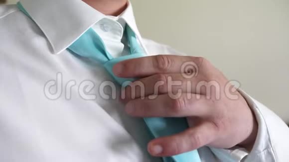 商人早上上班时双手系着绿松石领带换上白衬衫企业雇员的概念视频的预览图
