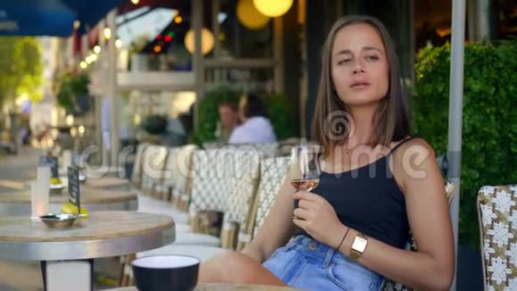 法国女孩在巴黎的街头咖啡馆喝一杯酒视频的预览图