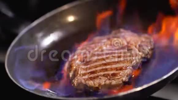 烧烤炉上烤着一个漂亮的炉火美味的牛排热腾腾的烧烤架慢动作视频的预览图