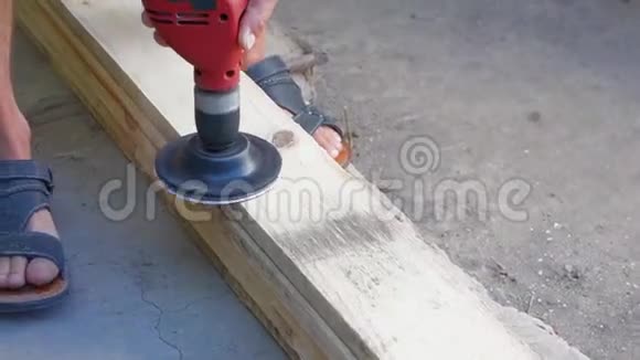一个人用钻头上的喷嘴擦板用砂纸打磨木质木材视频的预览图