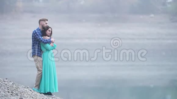 一对时尚的夫妇在湖的背景下视频的预览图
