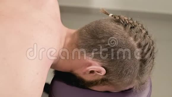 年轻男性理疗师按摩师为男性做手部伸展和肩胛骨的治疗性按摩视频的预览图