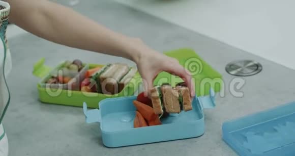 特写女士早上为她的孩子准备健康的午餐盒视频的预览图