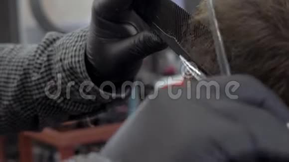 理发店的理发师用剪刀剪头发理发师在工作过程中手理发师理发视频的预览图