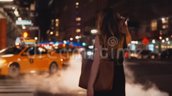 后景年轻美丽的女人站在人行横道附近交通道路在纽约美国市中心视频的预览图
