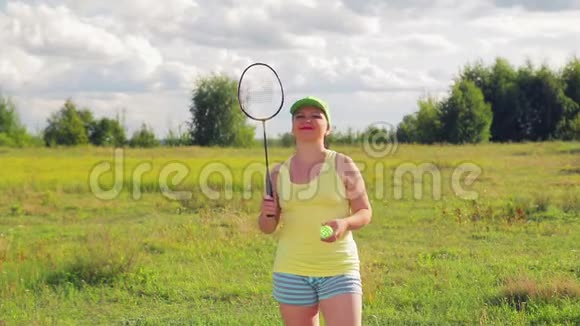 一个在空地上打羽毛球的女人发球和击球视频的预览图