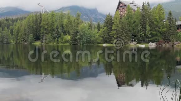 平静的清澈的湖边木酒店视频的预览图