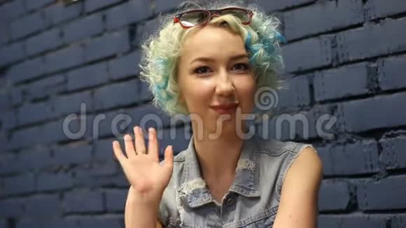 友好的积极微笑的女人用她的手挥手在会上欢呼朋友视频的预览图