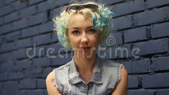 一幅美丽的蓝发女孩的头像卷发看着相机视频的预览图