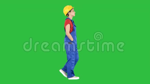 女建筑工人走在口袋上的绿色屏幕铬钥匙视频的预览图