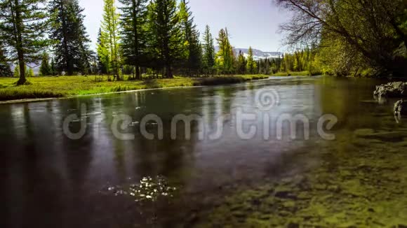 山河在前景移动藻类背景上的雪峰一天的时间视频的预览图