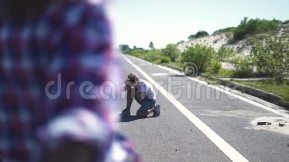 男子摄影师拍摄年轻女子与摩托车户外摆姿势年轻的摄影师视频的预览图