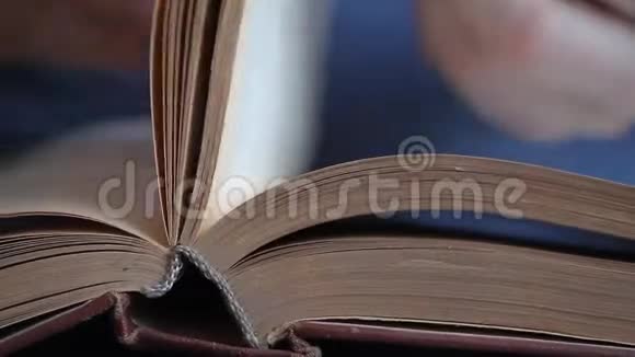 一个人用俄语翻阅一本书用手指翻阅书页研究书页视频的预览图