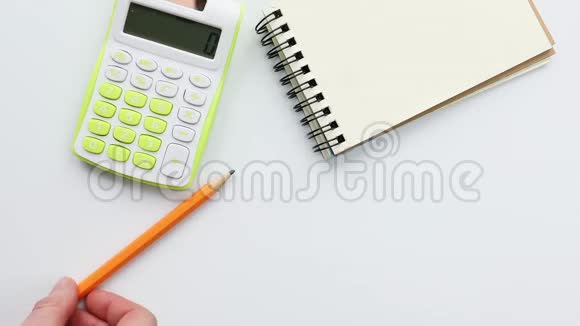 桌上的计算器和笔记本移动铅笔视频的预览图