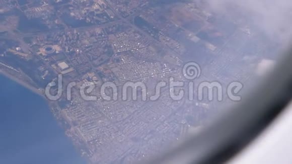 从一架客机的窗户往下看从一个高度到云层和陆地视频的预览图