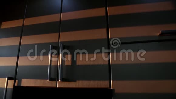 从威尼斯百叶窗移动的条纹阴影显示在厨房橱柜上视频的预览图