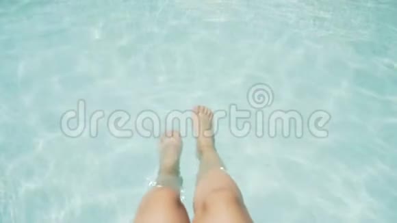 女性优雅的腿在游泳池里从上面看蔚蓝的水4K视频的预览图