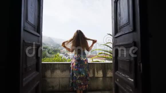 站在葡萄牙别墅阳台上的年轻女士视频的预览图