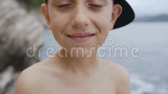 一个戴着尖顶帽子的可爱男孩看着相机的肖像可爱的快乐男孩7至8岁的特写镜头视频的预览图