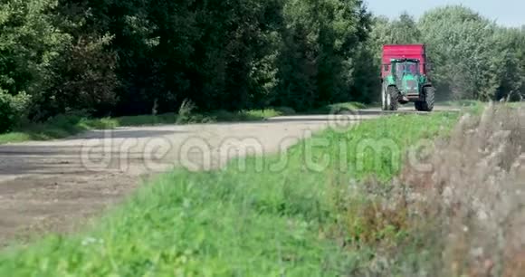 夏季的农场卡车和一辆拖车白天在路上行驶视频的预览图