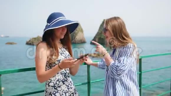 两个年轻女人在大海的背景上自拍视频的预览图