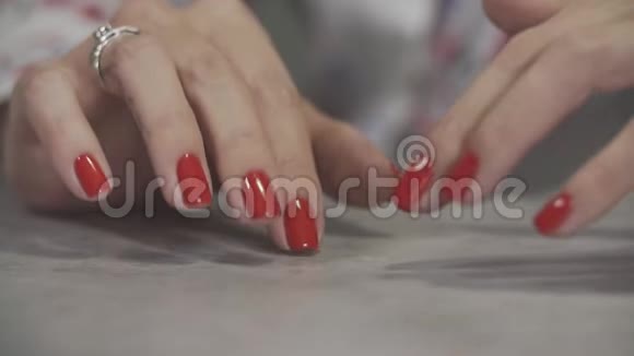 手臂闭合的女性美甲把女人的手指红色的指甲视频的预览图