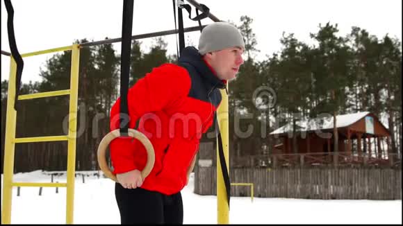 一个穿着红色夹克的人在冬天在露天做体操视频的预览图