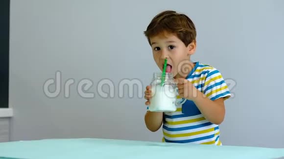 慢动作亚洲可爱的小孩在厨房喝牛奶开朗的男孩喜欢喝奶昔视频的预览图