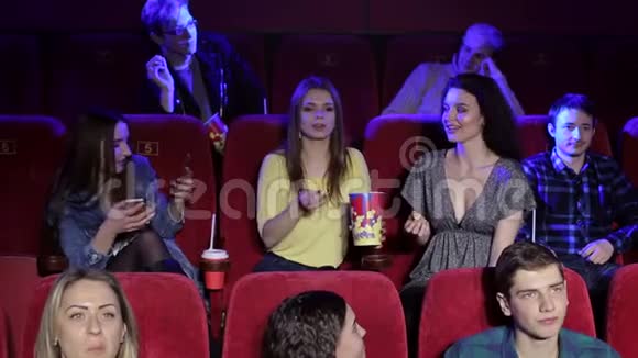 一群快乐的年轻朋友向电影院扔爆米花视频的预览图