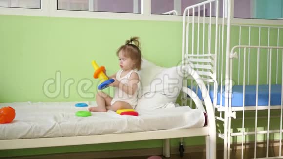 婴儿在床上玩金字塔和彩色戒指学前和幼儿园儿童的教育玩具儿童玩具视频的预览图