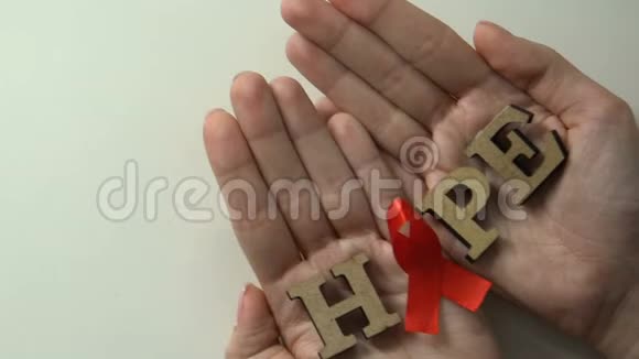 希望词手上有红丝带艾滋病毒治疗研究拯救生命的理念视频的预览图