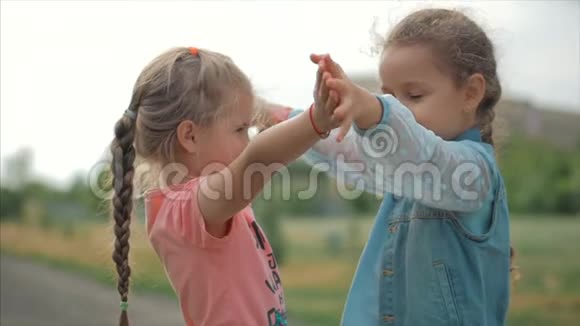两个微笑卷曲可爱的姐妹紧紧地拥抱着对方快乐童年积极情绪真情实感视频的预览图
