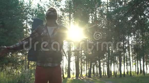 快乐的年轻人背着背包在森林里愉快的夏季野营之旅慢悠悠的视频的预览图