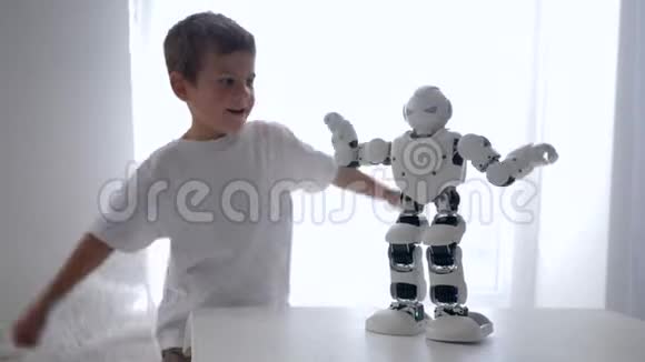 教育玩具可爱的小男孩重复机器人的动作人工智能特写在房间里视频的预览图