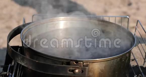茶的水是在木桩上的一个大平底锅里煮的视频的预览图
